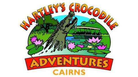 Logo for Hartley's Crocodile Adventures in Cairns featuring a crocodile, water lilies, a boat, trees, and the text "Hartley's Crocodile Adventures" and "Cairns." The design emphasizes ecotourism and nature.