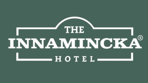 Logo of The Innamincka Hotel with white text on a green background. The hotel's name, signifying quality accommodation, is displayed in all capital letters within a rectangular frame with rounded corners.