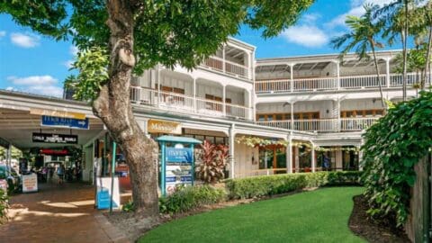A beautiful white building with balconies and wooden window frames.