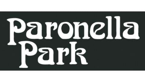 A sign with the text "Paronella Park" in stylized white letters on a dark background, offering information about tours and accommodation.