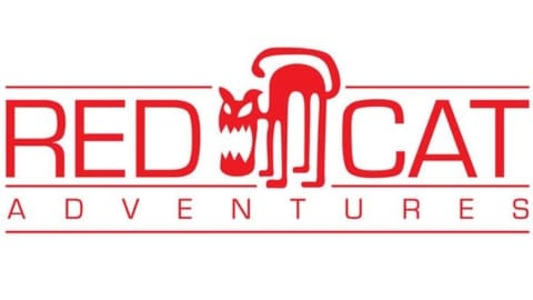 Logo of Red Cat Adventures featuring a stylized red cat, with the bold text "RED CAT ADVENTURES" in striking red capital letters.