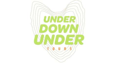 A light green and orange logo with the text "UNDER DOWN UNDER TOURS" layered over contour lines, emphasizing ecotourism and sustainable travel.