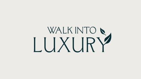 Logo with the text "WALK INTO LUXURY" in green, with two leaves adorning the letter "Y" in "LUXURY," highlighting our commitment to ecotourism.