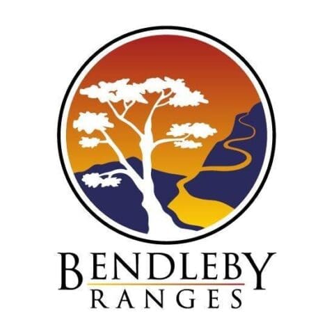 A logo featuring a stylized white tree with a winding path against a sunset background in a circular frame, above the text "Bendleby Ranges," encapsulating the natural beauty and serene landscapes of Bendleby Ranges.