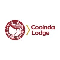 Logo of Cooinda Lodge featuring a maroon bird within a circular design next to the text "Cooinda Lodge" in maroon with a gold arrow pointing to the text, emphasizing its commitment to ecotourism.