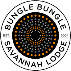 Circular logo for Bungle Bungle Savannah Lodge, established in 2004, featuring a dot pattern in the center.